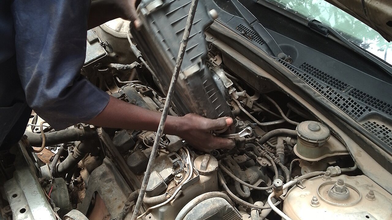Mechanic removing the air box to inspect an engine